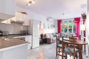 A modern kitchen with a built-in oven, microwave, and a stainless steel range hood.