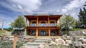 A two-story building with a wooden facade, large windows, and a balcony. - Unique cottage (Alberta)