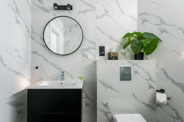 A modern bathroom with a white sink, black vanity, and a large mirror. - Old Town Residence - Premium Aparthotel (Kraków)