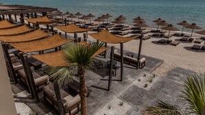 A beachside resort with outdoor seating areas, umbrellas, and a view of the sea. - Casa Cook Samos (Samos)