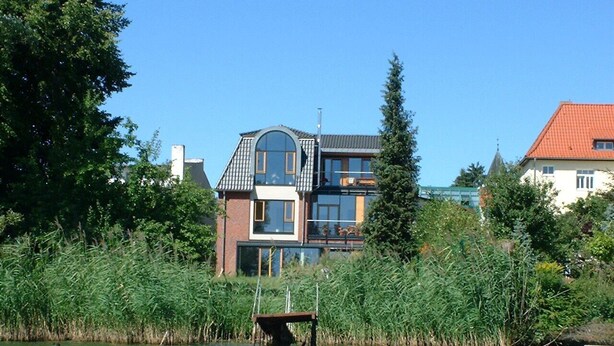 A house by a lake with a dock.