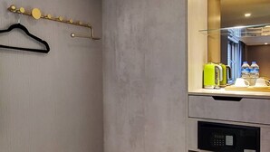A modern kitchen with a microwave, dishwasher, and a coffee maker. - Hinoen Hotel (Taipei)