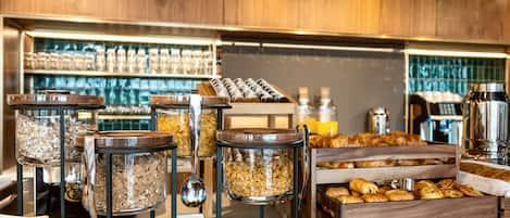 A breakfast buffet with various food items and containers.