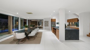 Enjoy meals in the spacious dining area with a long table and comfortable chairs.
