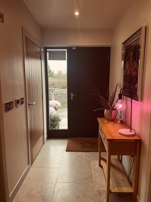 Enter a tranquil space with a balcony view, featuring a dark wood door and a star-shaped doormat.