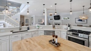 Enjoy cooking in this well-equipped kitchen with a central island, ample counter space, and integrated appliances.