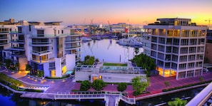 Stunning waterfront complex with modern architecture and balconies overlooking the marina.