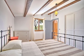 Classic bedroom with a bed, wardrobe, and dresser, offering a comfortable retreat.