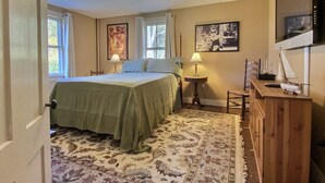 A bedroom with a bed, two bedside tables, a dresser, a television, and a window. - Historic Colonial...Close to Village Green (Litchfield)