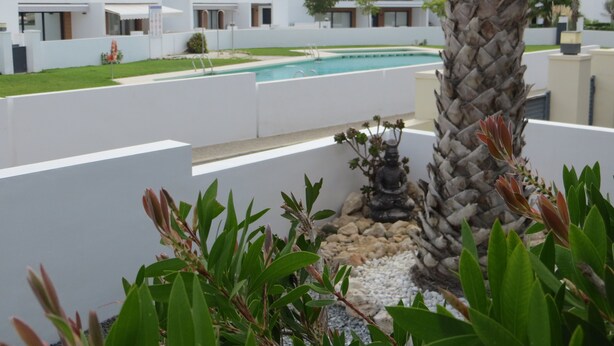 A modern hotel with a pool, white walls, and a palm tree. - Golf & Sea Top location (Villamartin)
