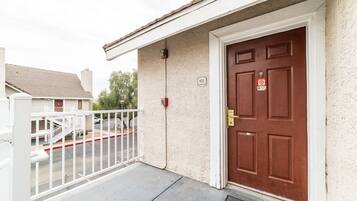 A residential building with a red door, a white mailbox, and a number '921' on the wall.