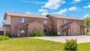 A two-story building with a flat roof, multiple windows, and a paved driveway. - Spacious Williams Retreat near Grand Canyon (Williams)