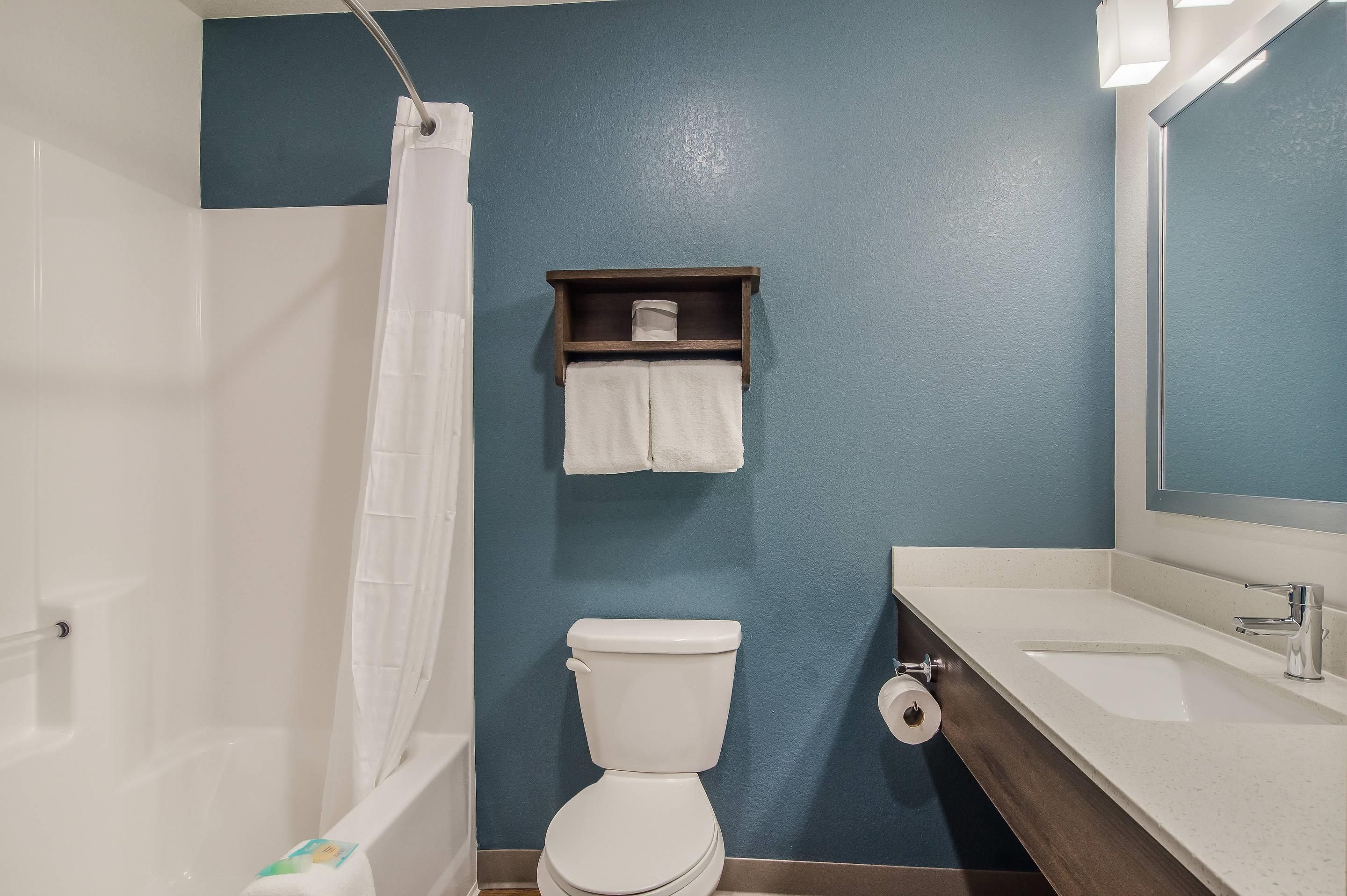 A bathroom with a bathtub, toilet, and sink.