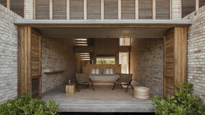 A modern outdoor seating area with a bench, two chairs, and a small table. - Terrestre, a Member of Design Hotels (Villa de Tututepec de Melchor Ocampo)