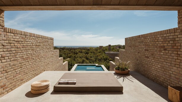 A rooftop pool area with a clear view of the surrounding landscape, a lounge with a cushion and a woven basket, and a potted plant. - Terrestre, a Member of Design Hotels (Villa de Tututepec de Melchor Ocampo)
