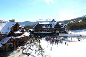 A ski resort with wooden buildings, a ski lift, and a snow-covered landscape. - Grand Timber Lodge - Holiday&new Years (Breckenridge)