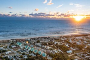 An aerial view of a coastal area with a row of houses and a beach. - Stay Salty (Panama City Beach)
