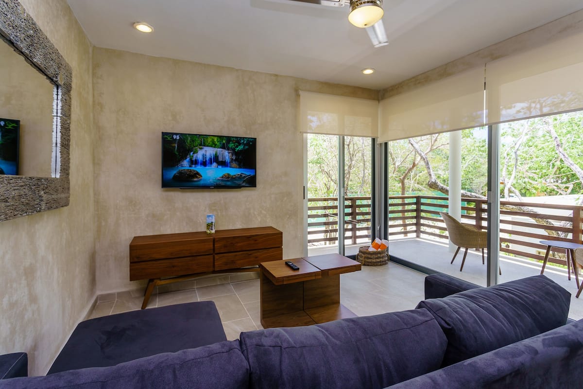 Signature Apartment, 2 Bedrooms, Pool View | Living area | Flat-screen TV