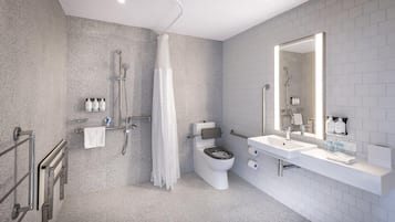 A modern bathroom with a shower, toilet, and sink.