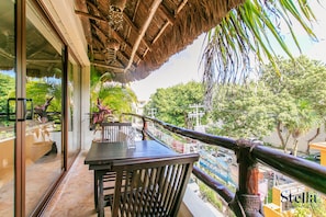 Enjoy the serene view of the surrounding greenery and urban landscape from this balcony.
