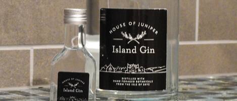 Two bottles of Island Gin on a tiled surface.
