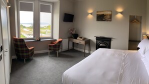 A hotel room with a bed, a desk, a chair, and a view of the outdoors. - House Of Juniper - The Manse (Strath)