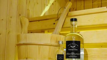 A wooden cabinet with a bottle of Island Gin and a smaller bottle of gin, both labeled with the same brand.