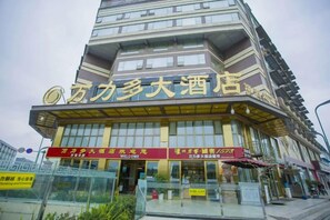 A multi-story building with a prominent sign indicating it is a hotel. - Wan Li Duo Hotel (Mingshu) (Chengdu)