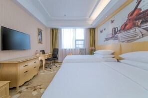 A hotel room with a bed, a desk, a chair, a television, and a mural on the wall. - Vienna Hotel (Wuhan Sports Center) (Wuhan)