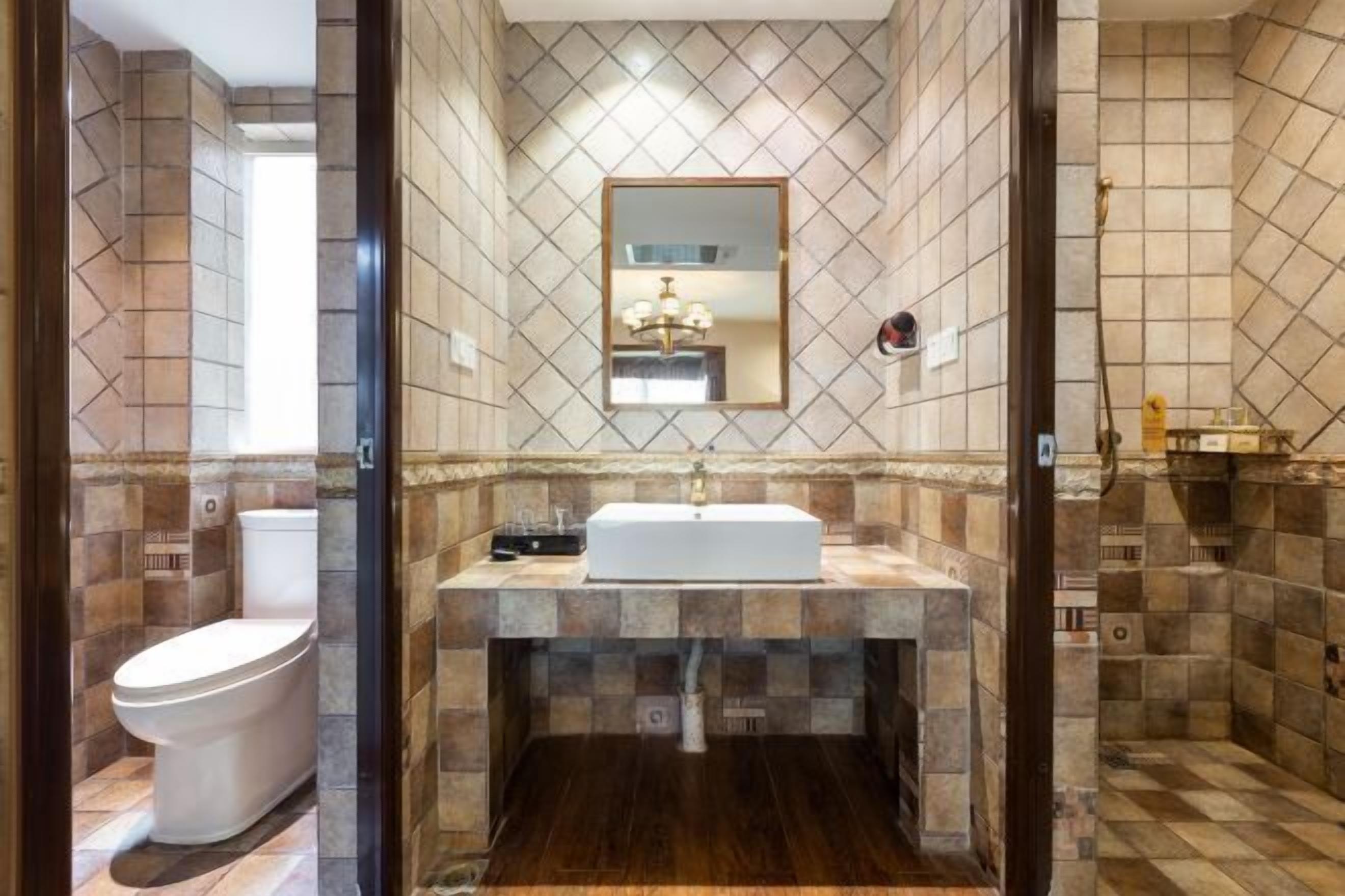 A bathroom with a white sink, a mirror, and a shower area.