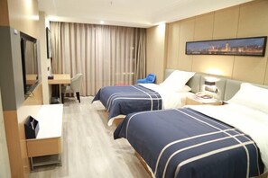 A hotel room with two beds, a desk, a chair, a TV, and a cityscape painting on the wall. - lanyi Hotel (Guiding)