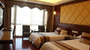 A hotel room with two beds, a desk, a chair, and a large window with curtains. - Baiweilin Hotel (Cangnan)