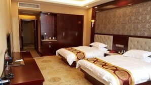 A hotel room with two beds, a desk, a wardrobe, and a television. - Guyuecun Hotel (Yongde)