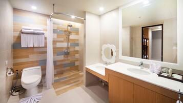 A modern bathroom with a shower, toilet, and vanity.