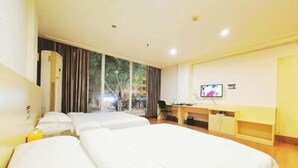A hotel room with two beds, a desk, a TV, and a window with curtains. - Xinju Express Hotel (Hezhou)