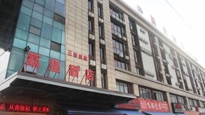 A hotel with a modern facade, featuring large windows and a prominent signage. - Lihuang Hotel (Jiaxing)