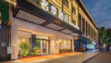 A hotel with a modern facade, large windows, and a well-lit entrance.