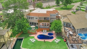 A residential property with a swimming pool, a wooden deck, and a boat dock. - Lakefront Retreat with Pool, Spa, Golf, Fishing,  Boat slip, Kayaks & Marina (Montgomery)