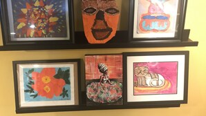 A wall with four framed artworks. - Welcome Home!! (Marietta)