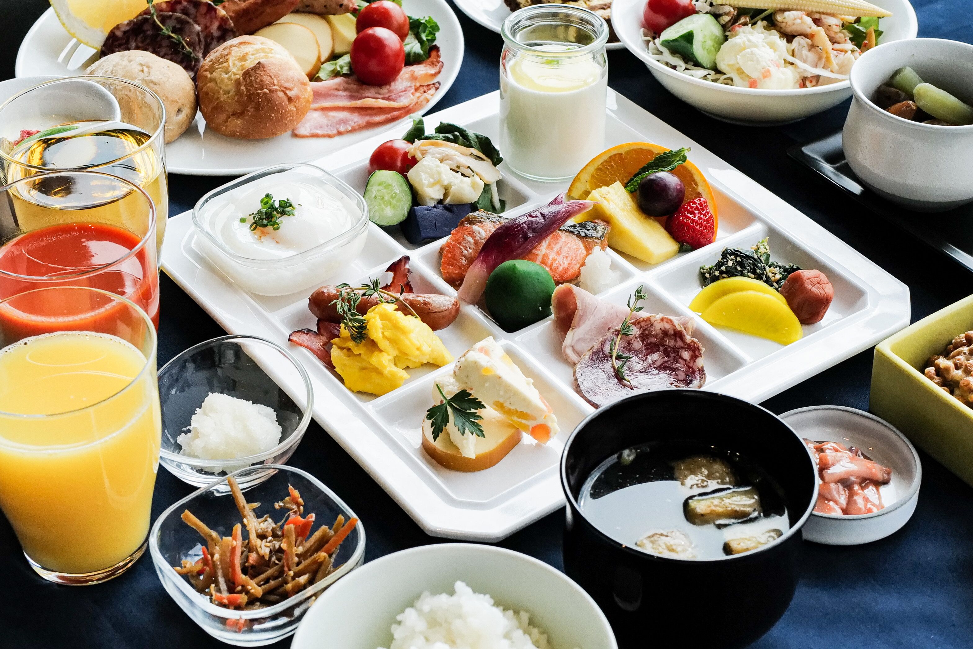 A breakfast buffet with various food items and drinks.