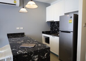 1 Bedroom at Palmyrah Surin Condo | Private kitchen | Fridge, microwave, stovetop, toaster