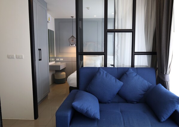 1 Bedroom at Palmyrah Surin Condo | Living area | Flat-screen TV
