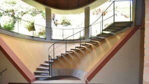A curved staircase with metal railings, leading to an upper level. - Apartment in Verbania near Lake and Islands (Verbania)