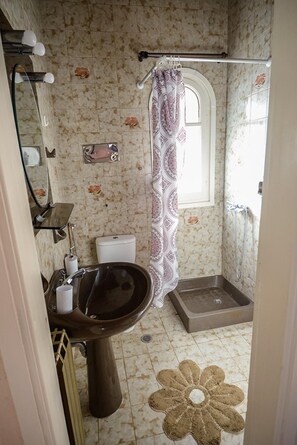 A bathroom with a sink, toilet, shower, and a window. - Villa Litsa Large Private Pool Walk to Beach Sea Views A C Wifi (Corfu)