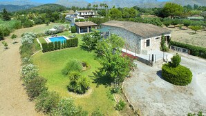 A large stone house with a swimming pool, surrounded by well-maintained gardens and a mountainous backdrop. - VILLA PENASO - PRIVATE POOL AND HEAVENLY GARDEN (Pollensa)