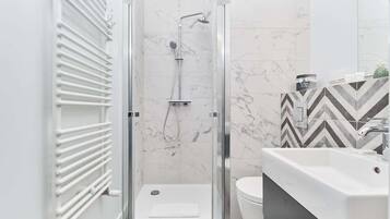 Shower, hair dryer, towels, shampoo