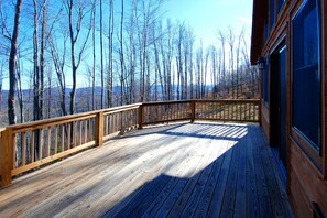 A wooden deck with a railing, overlooking a forested area. - Aurora. A beautiful name for a beautiful home in beautiful Canaan Valley! (Davis)