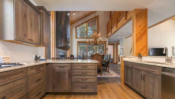A spacious kitchen with wooden cabinets, a large island, and a chandelier. - Grand Antler Lodge: Spacious, Updated, Sleeps 16 (Breckenridge)