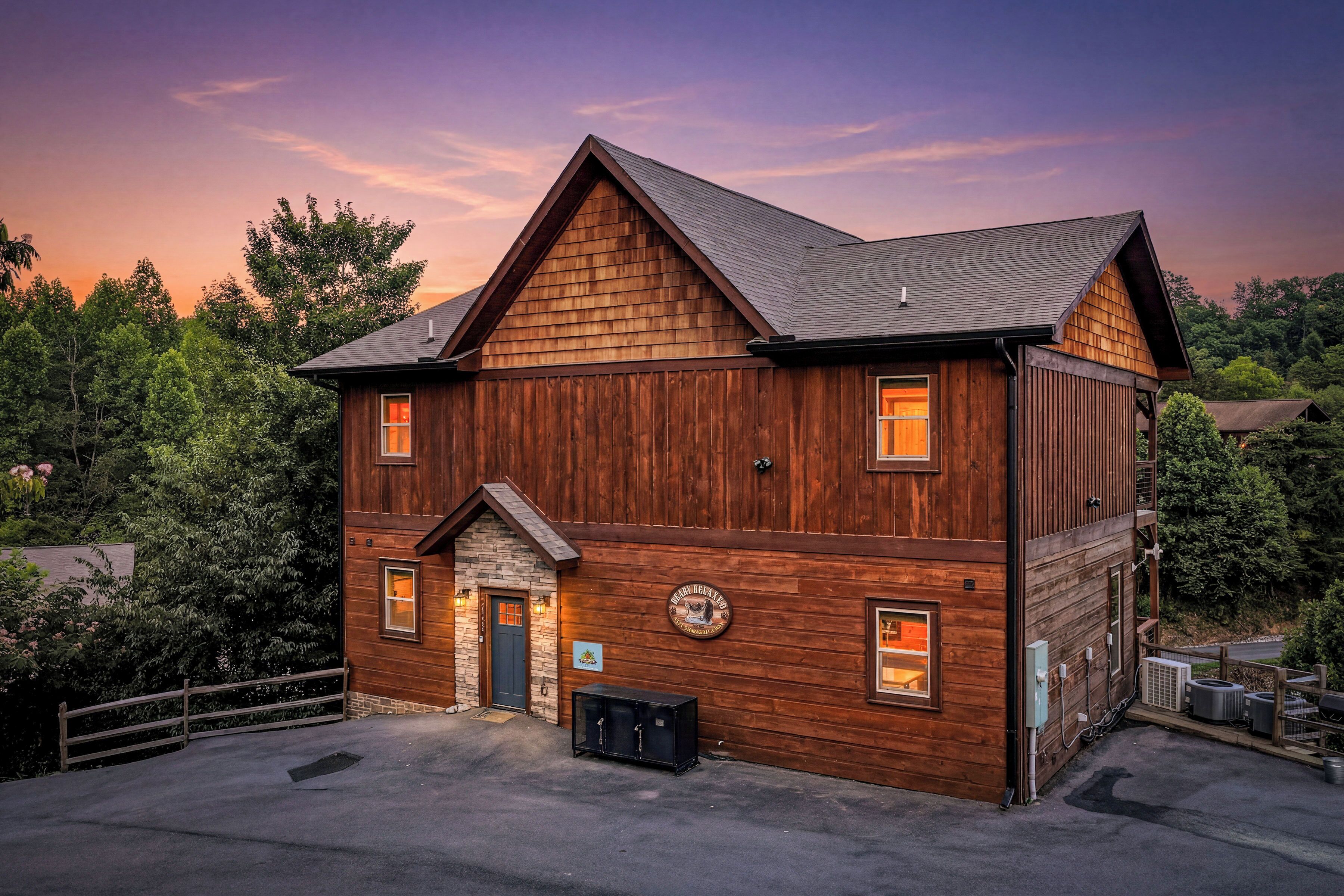A two-story wooden building with a gabled roof, a stone entrance, and a sign indicating a relaxation area.
