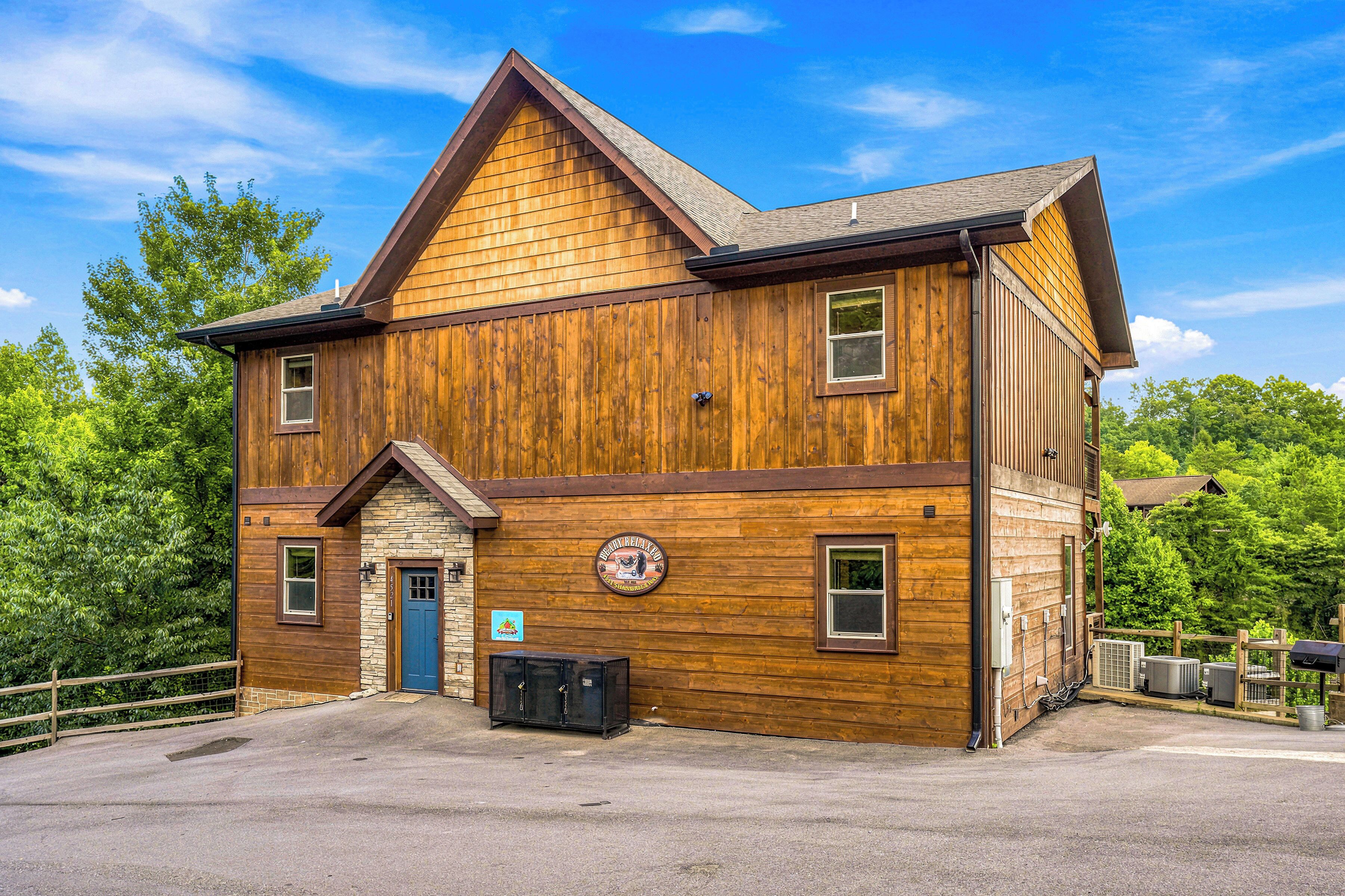 A two-story wooden building with a stone foundation, a blue door, and a sign indicating a restaurant.